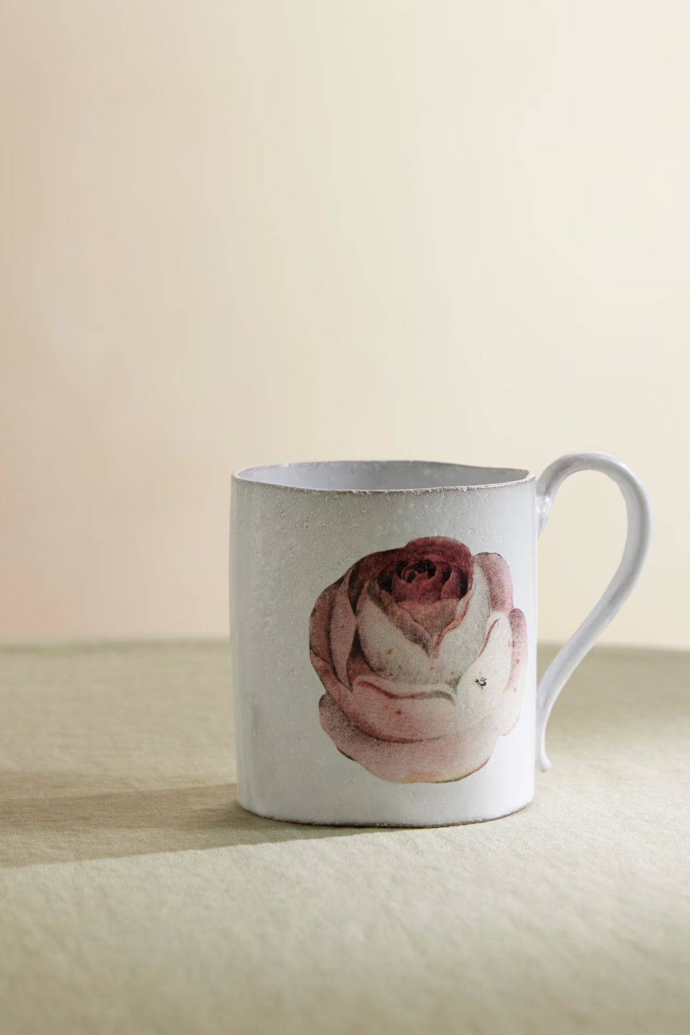 White mug with pink rose and insect illustration