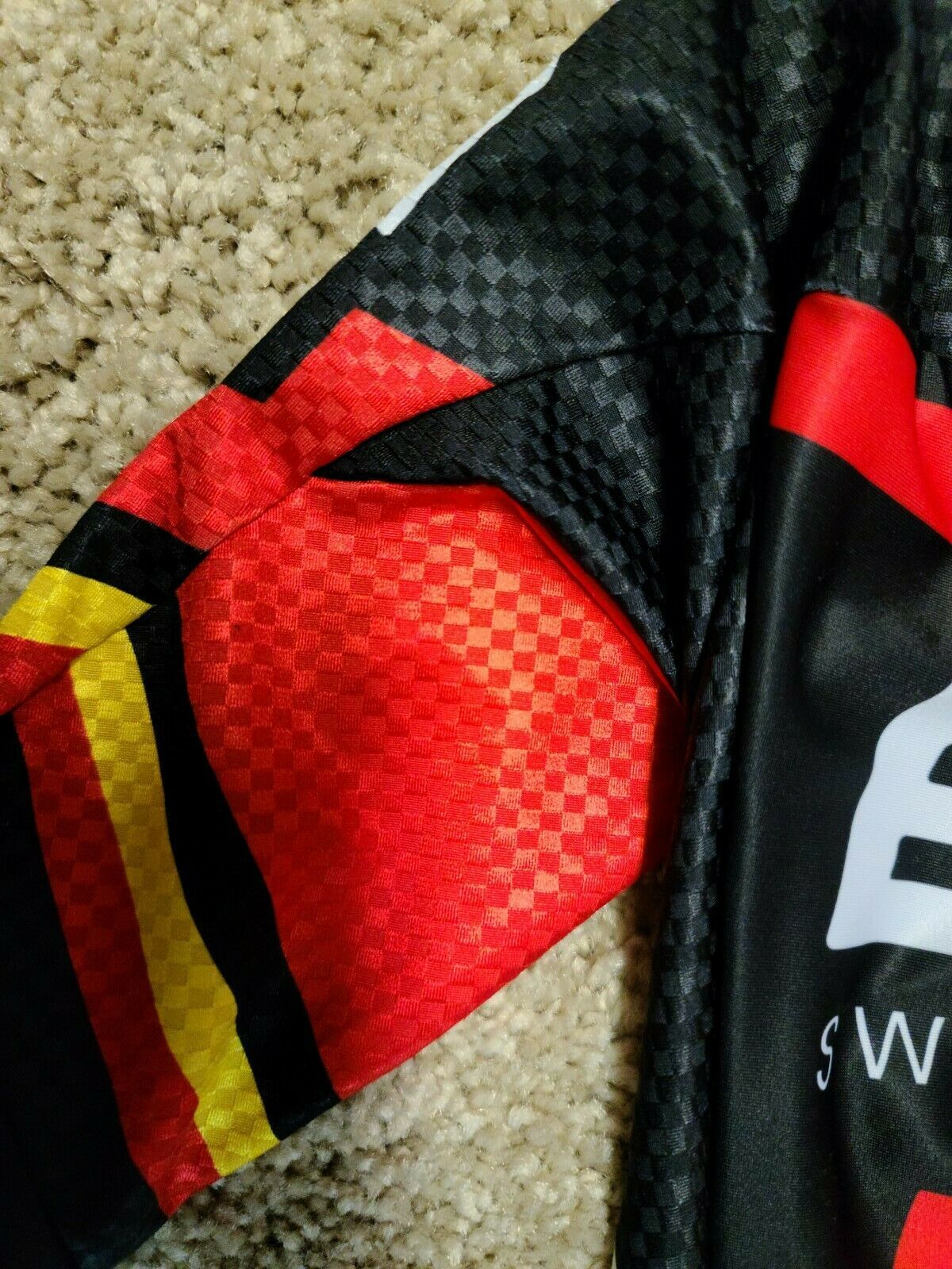 The sleeves, collar and leg cuffs boast the black, gold and red stripes that signify that Gilbert is a past time trial national champion