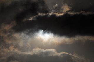 Clouds Partially Hide Solar Eclipse