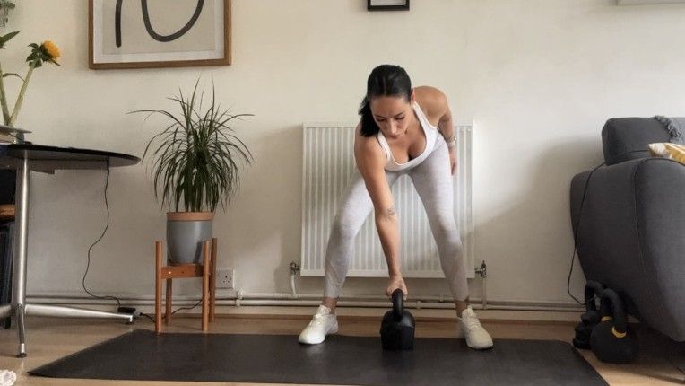 Writer Sam in start position for lateral kettlebell swings in home