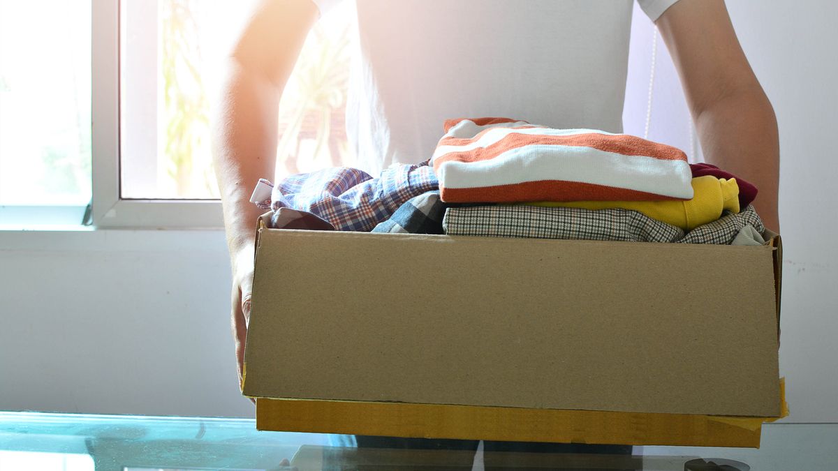 Man holding box of clothes