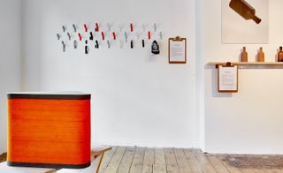 PostlerFerguson's 'Staeckler' shoe hooks (left), from its production company Papafoxtrot, hangs shoes off the wall at a gentle angle; and Felix de Pass is exhibiting his 'Universal Bottle' created for London-based distillery Sweetdram.