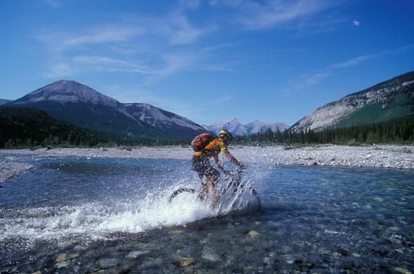 A rider crosses a stream at the TransRockies.