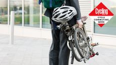 Image shows a person holding a folding bike best folding bikes.