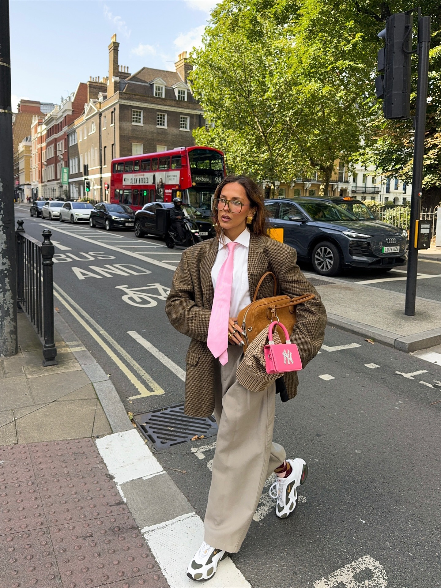 Fashion personSofia McOelho @sofiamcoelho wears a oversized blazer, tapered trouser and chunky dad trainers.