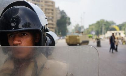 A member of the Egyptian military stands at a roadblock in Cairo the morning after democratically elected President Mohammed Morsi was ousted.