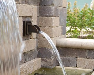 OASE spout in wall as garden water feature