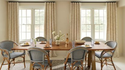 Neutral curtains in a traditional dining room