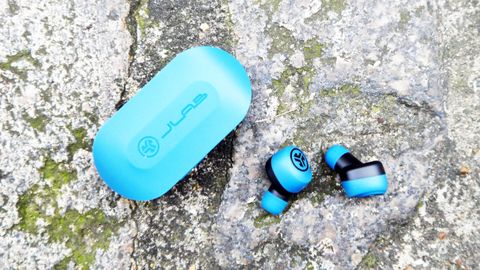 jlab go air earbuds with their case on a stone surface