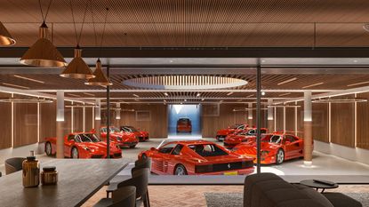 The Garage Deluxe concept by Jonathan Clark Architects, an underground garage with central skylight, wood-clad interior and red Ferraris parked