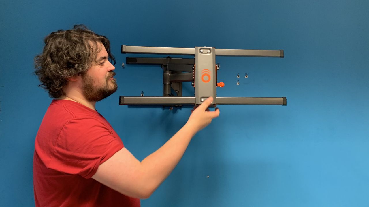 Grey tv wall bracket on blue wall