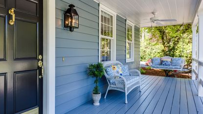 Front porch ideas showing a covered porch with bench and hanging bench seat