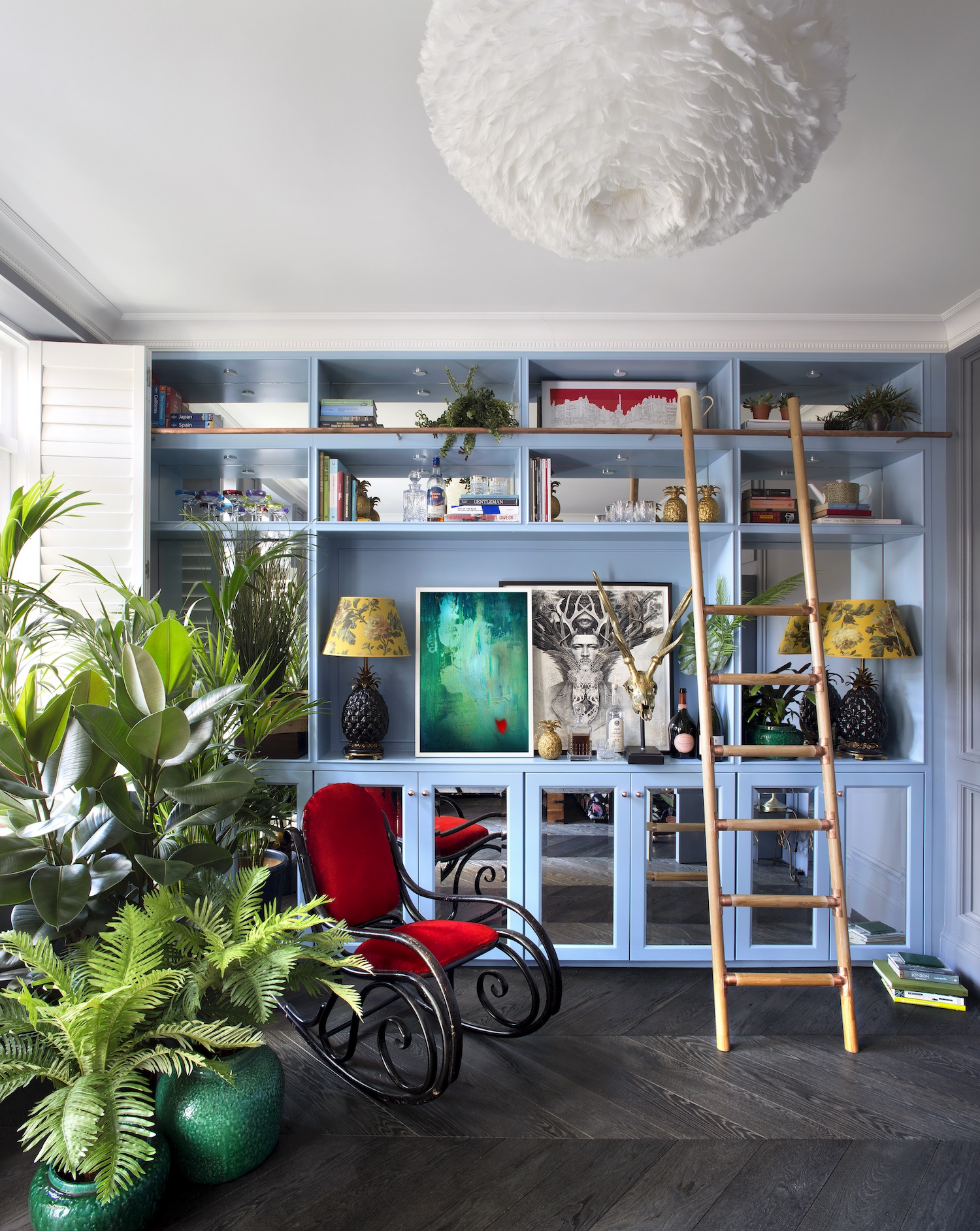 Small living room with floor to ceiling built in storage painted blue