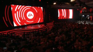 EA logo on jumbo stage screen before darkened crowd.
