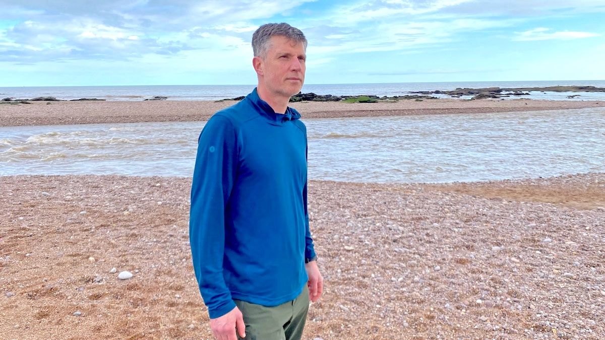 Man on beach wearing Smartwool Men&#039;s Active Mesh Hoodie