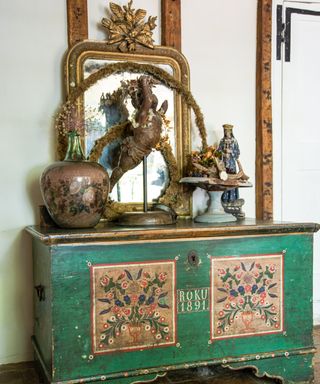 antique painted trunk with anique and vintage items on display on top