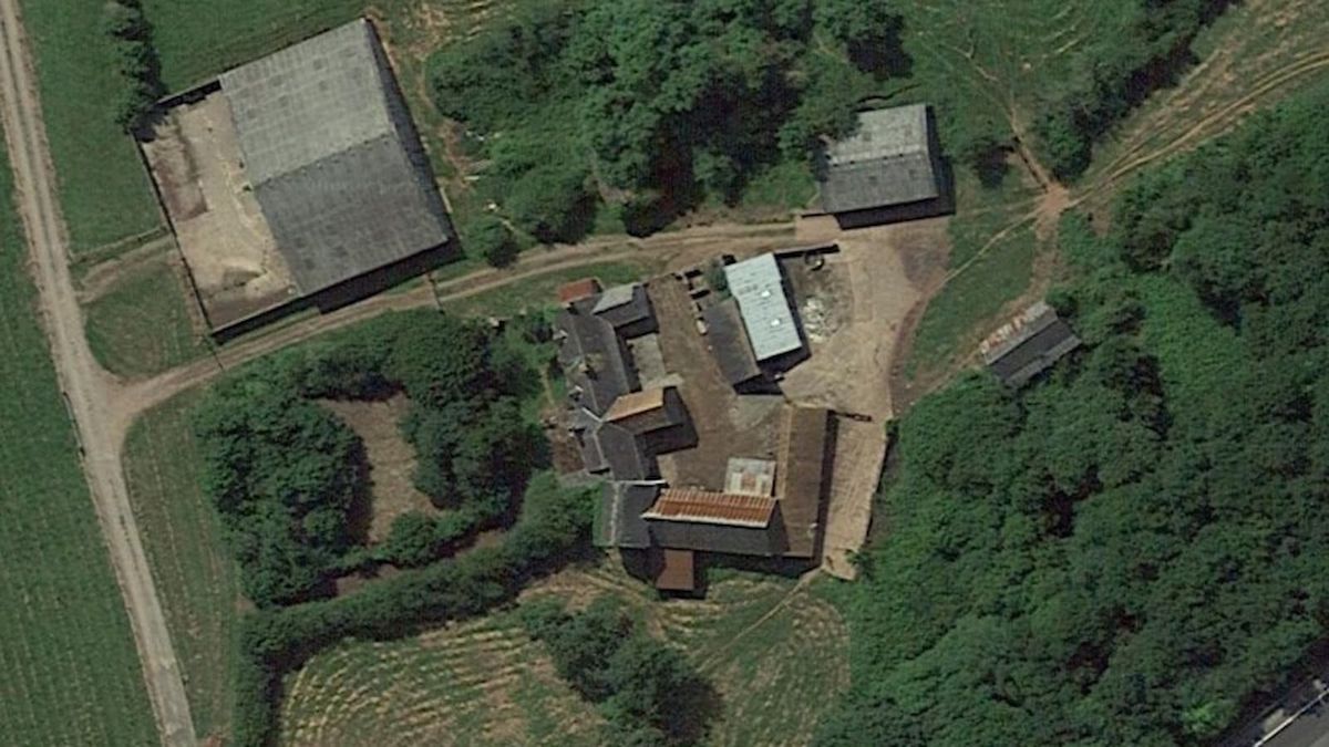 An overhead shot of a farmhouse and large barn