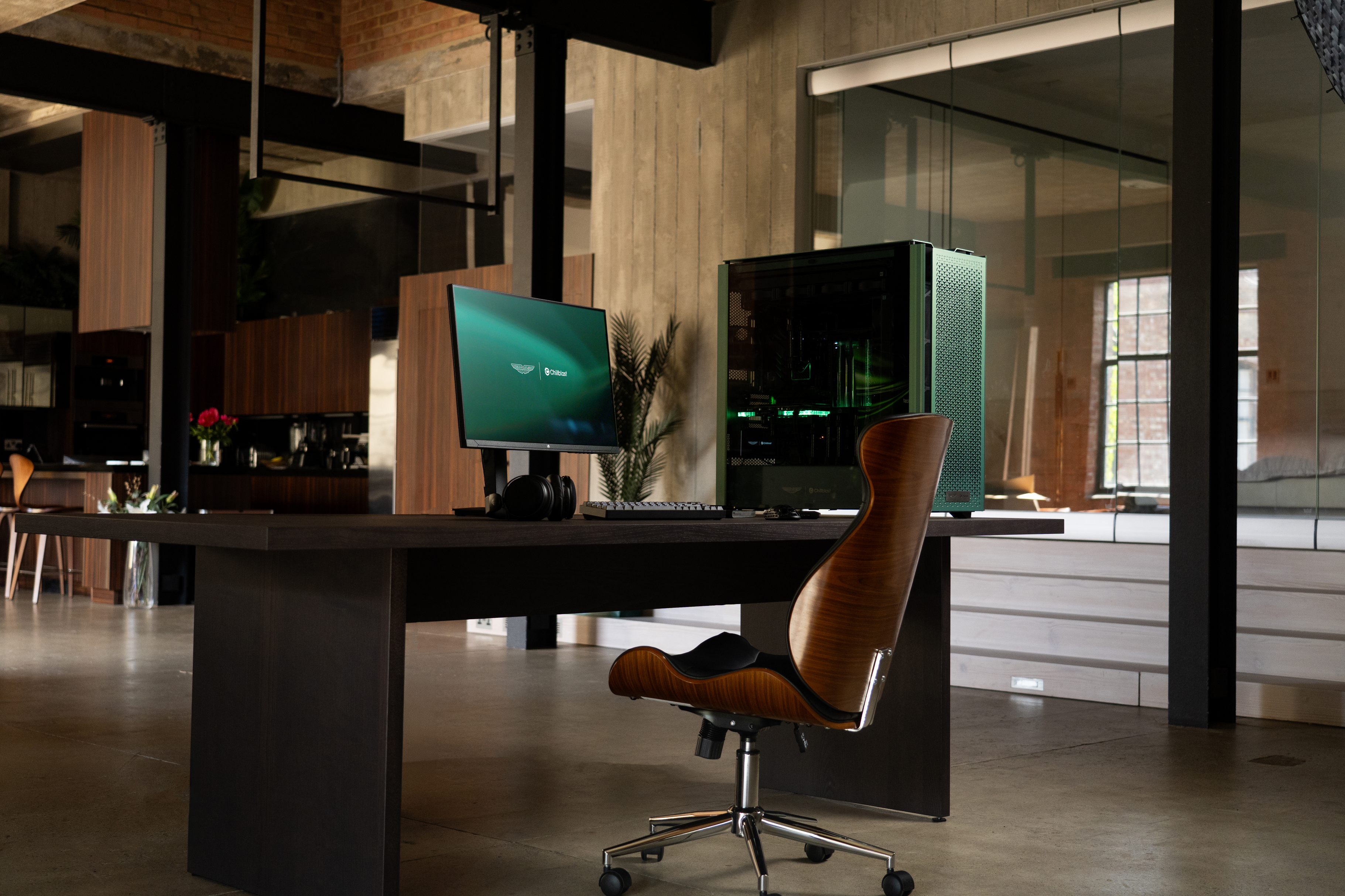 A PC gaming rig designed by Aston Martin, green with wood pannelling