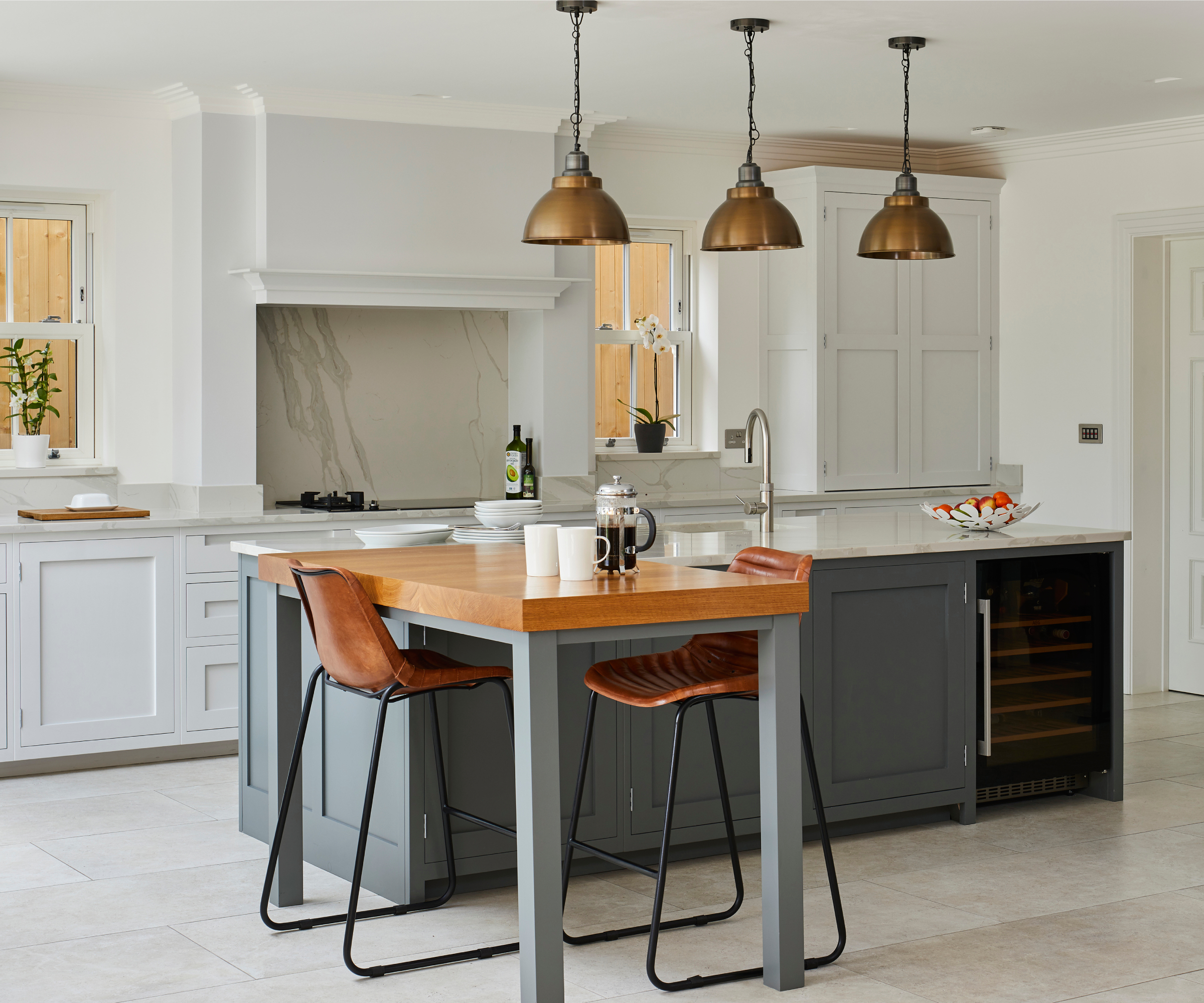 small L shaped island with two brown stools on opposite sides