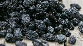 Raisins spilling out on wooden table