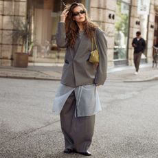 a model wears a grey tailored suit