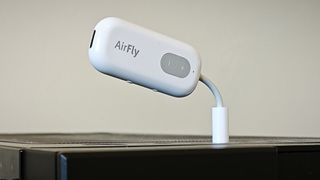 A white Twelve South AirFly Bluetooth transmitter plugged into a computer's headphone jack