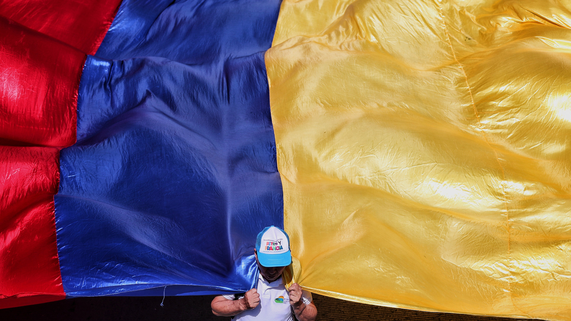 A person holds Colombia's national flag