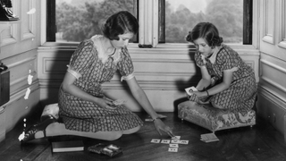 Princess Elizabeth and Princess Margaret play a card game at the Royal Lodge, Windsor, 22nd June 1940