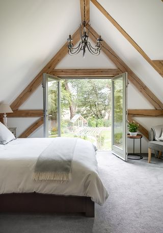 bedroom with oak beams and french doors