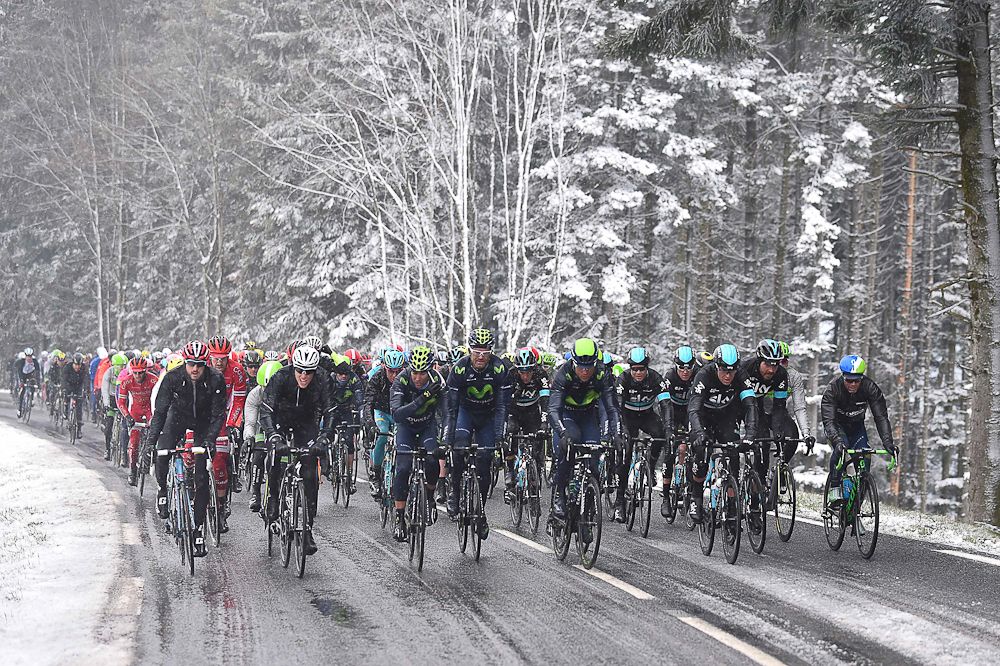 The peloton rides together as the snow falls on Paris-Nice.