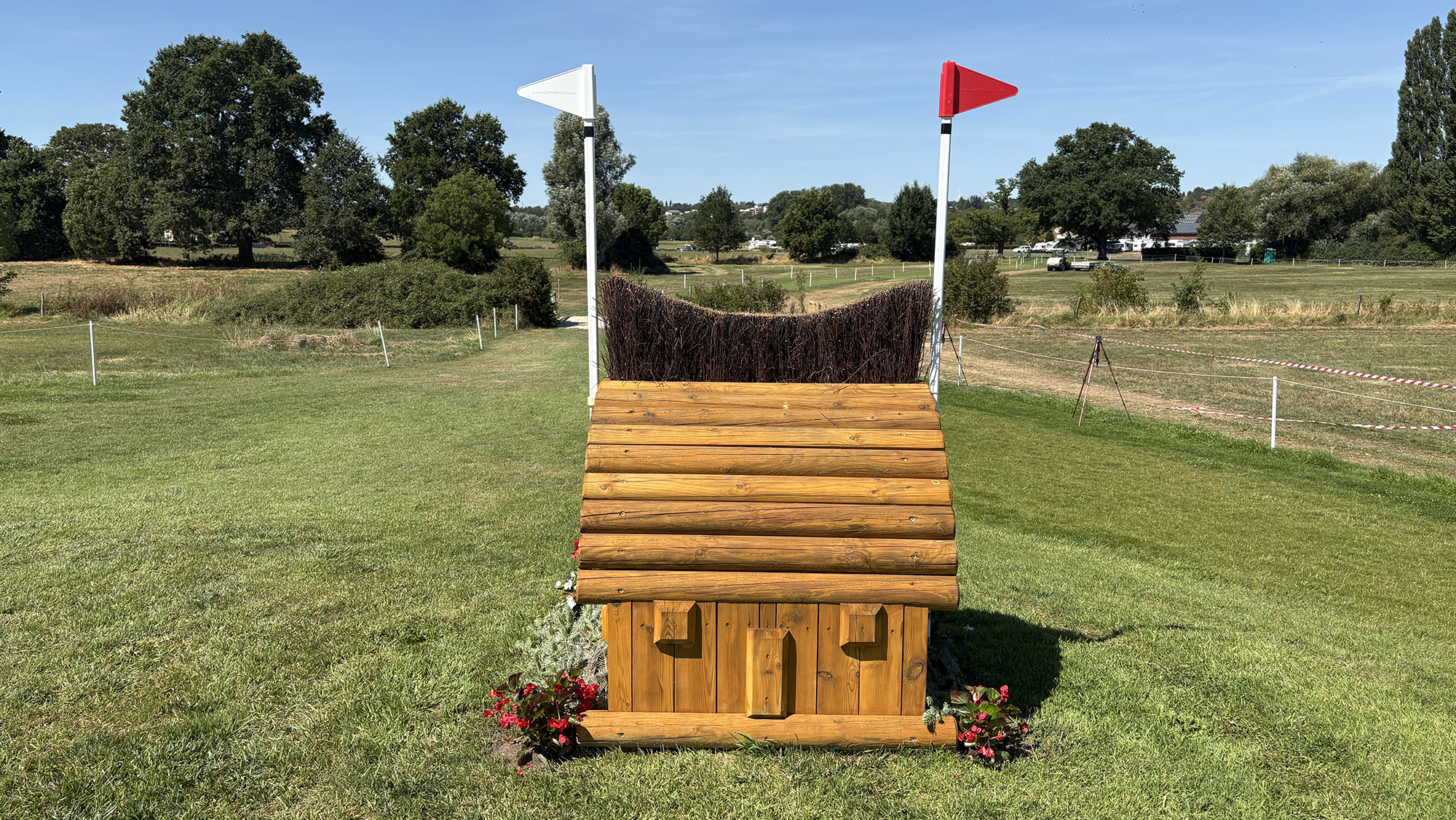 A narrow fence made of brush on top of wood on the eventing World Championships cross-country course