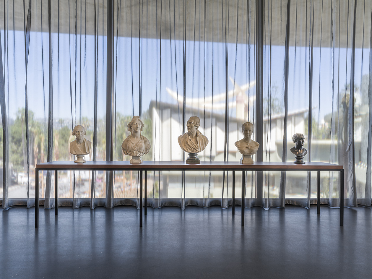 David Geffen Galleries at LACMA, view of ancient busts against glazing and curtains