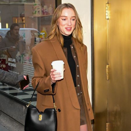 Phoebe Dynevor wears a roll neck knit underneath a jacket and coat.