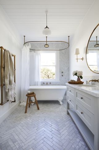 white bathroom tile in a bathroom with rolltop bath