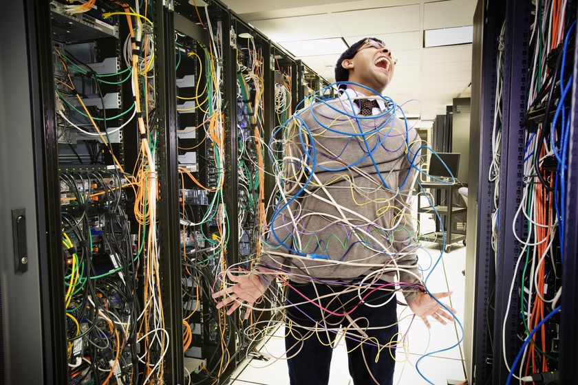 Network tech entangled in cables
