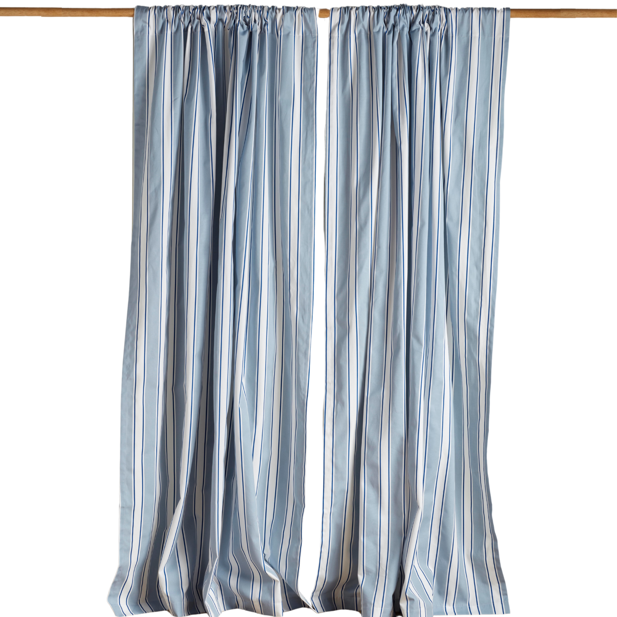 blue and white striped curtains on a wooden rod