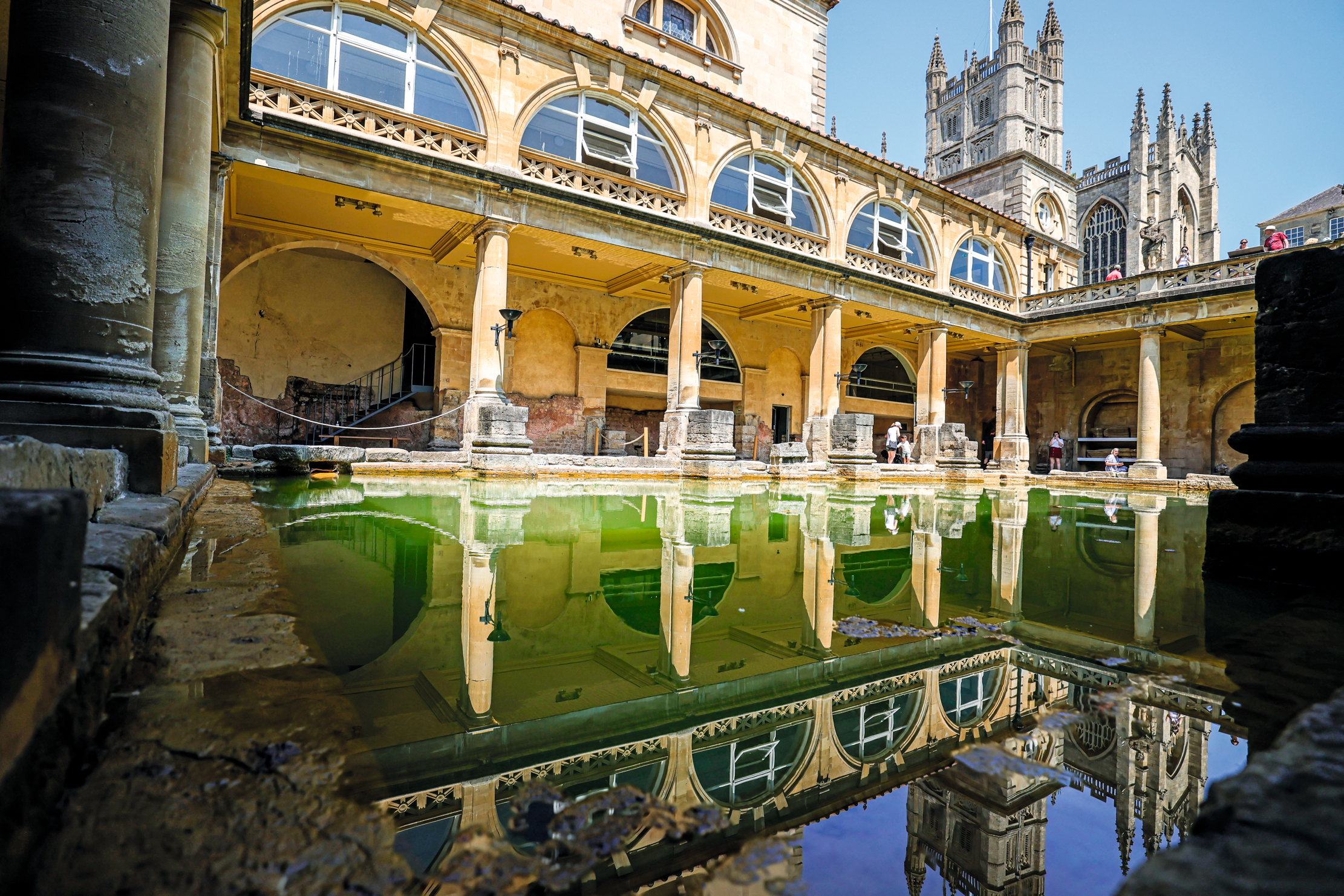 A general view of the Roman Bath, which is considered one of the most important cultural heritages of the city and has survived from the Roman period to the present day, in Bath, United Kingdom on June 19, 2025. The bath, which draws attention with its architecture, consists of four main parts: a sacred spring, a temple, a bath area and a museum. More than a million tourists visit the Roman Bath annually, although visitors are prohibited from entering the water due to health risks. (Photo by Nurettin Boydak/Anadolu via Getty Images)