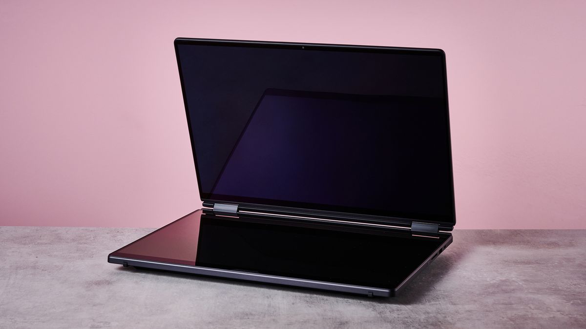 Three-quarter view of ASUS ROG Zephyrus Duo 2026 on a desk with pink wall in background