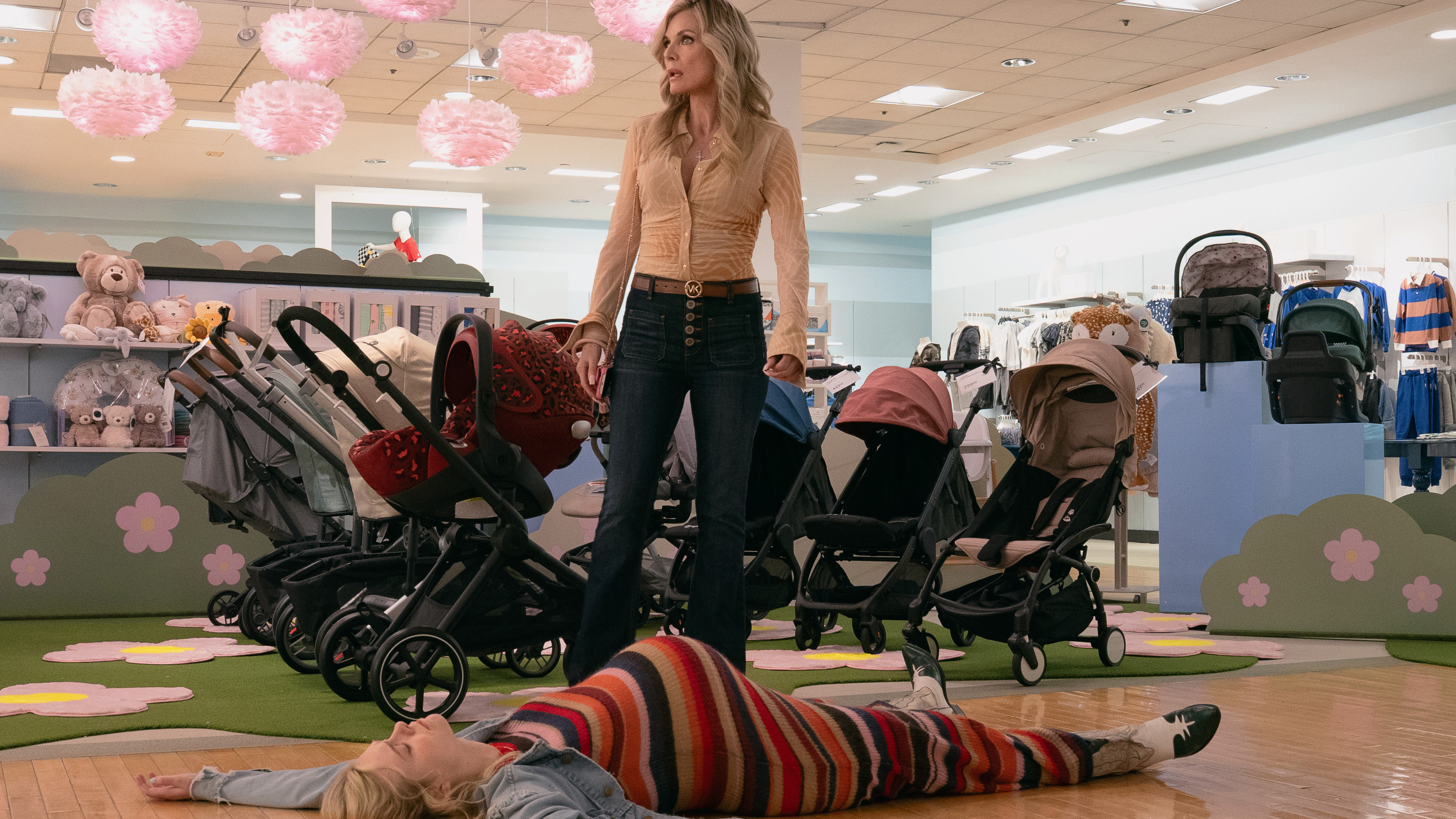 A still from the upcoming Apple TV series Margos Got Money Troubles, showing Elle Fanning as margo laid on the floor and Michelle Pfeiffer as her mother stood above her