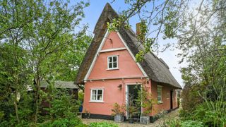 Suffolk cottage pink with thatched roof