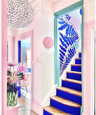Pink and blue hallway with royal blue staircase paint ideas and pink blue and green feature wall