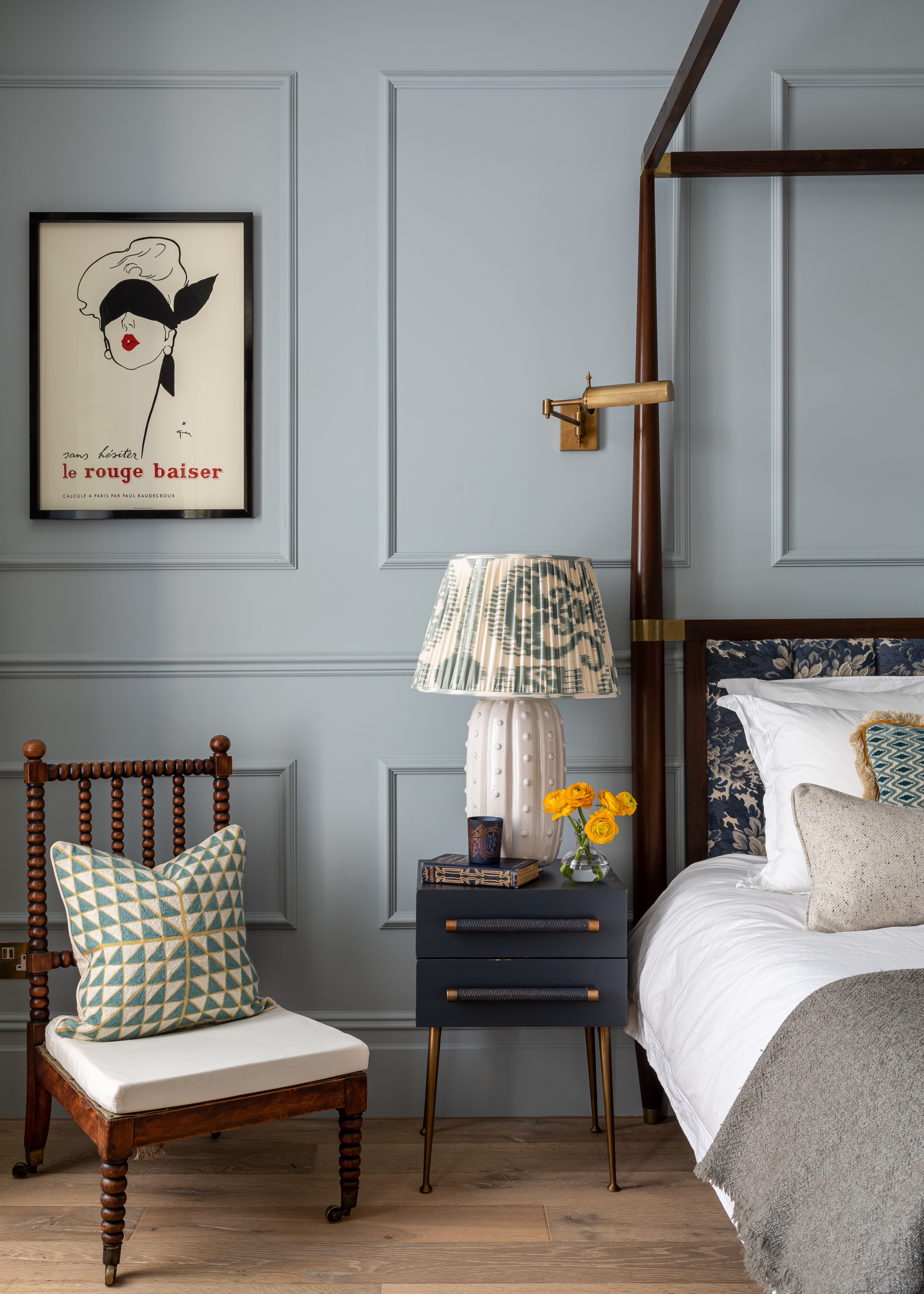 blue bedroom with wall paneling and antique chair