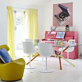 room with pink piano glass table and chairs