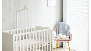 The Cubo Ai baby monitor positioned above a baby's cot in a modern nursery