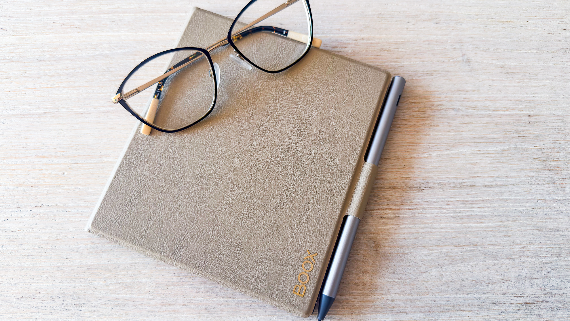 The Boox Go 7 ereader case with stylus and a set of spectacles