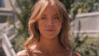 Sydney Sweeney smiling outside in Anyone But You