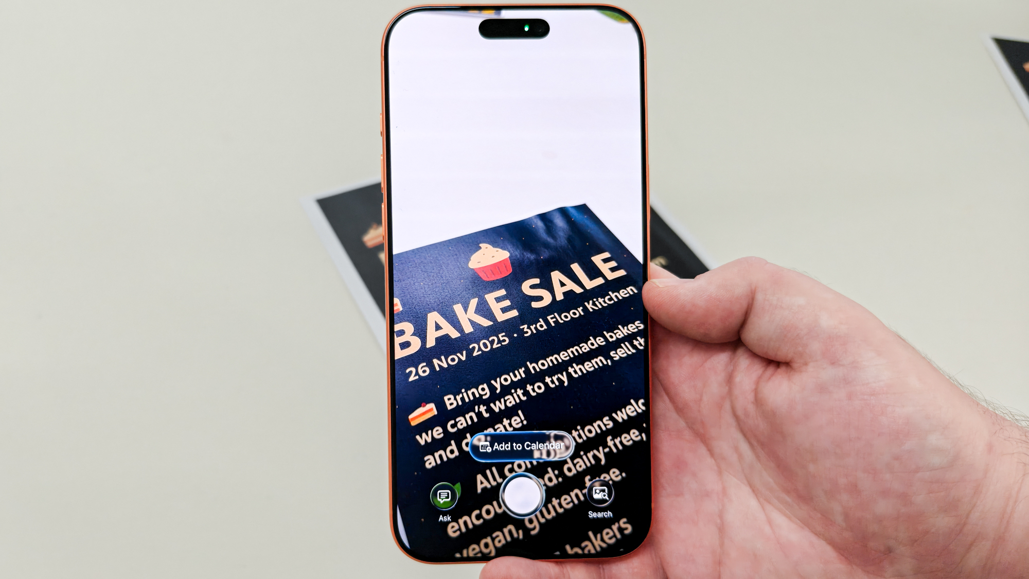 iPhone 17 Pro Max taking a Visual Intelligence capture of a bake sale flyer