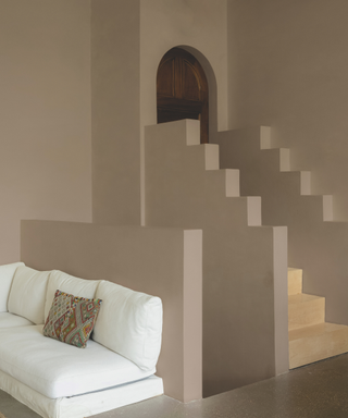 pink staircase in pale pink with white sofa