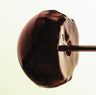 After 60 minutes of water flow, the once spherical "lollipop" develops a flat pockmarked back surface.
