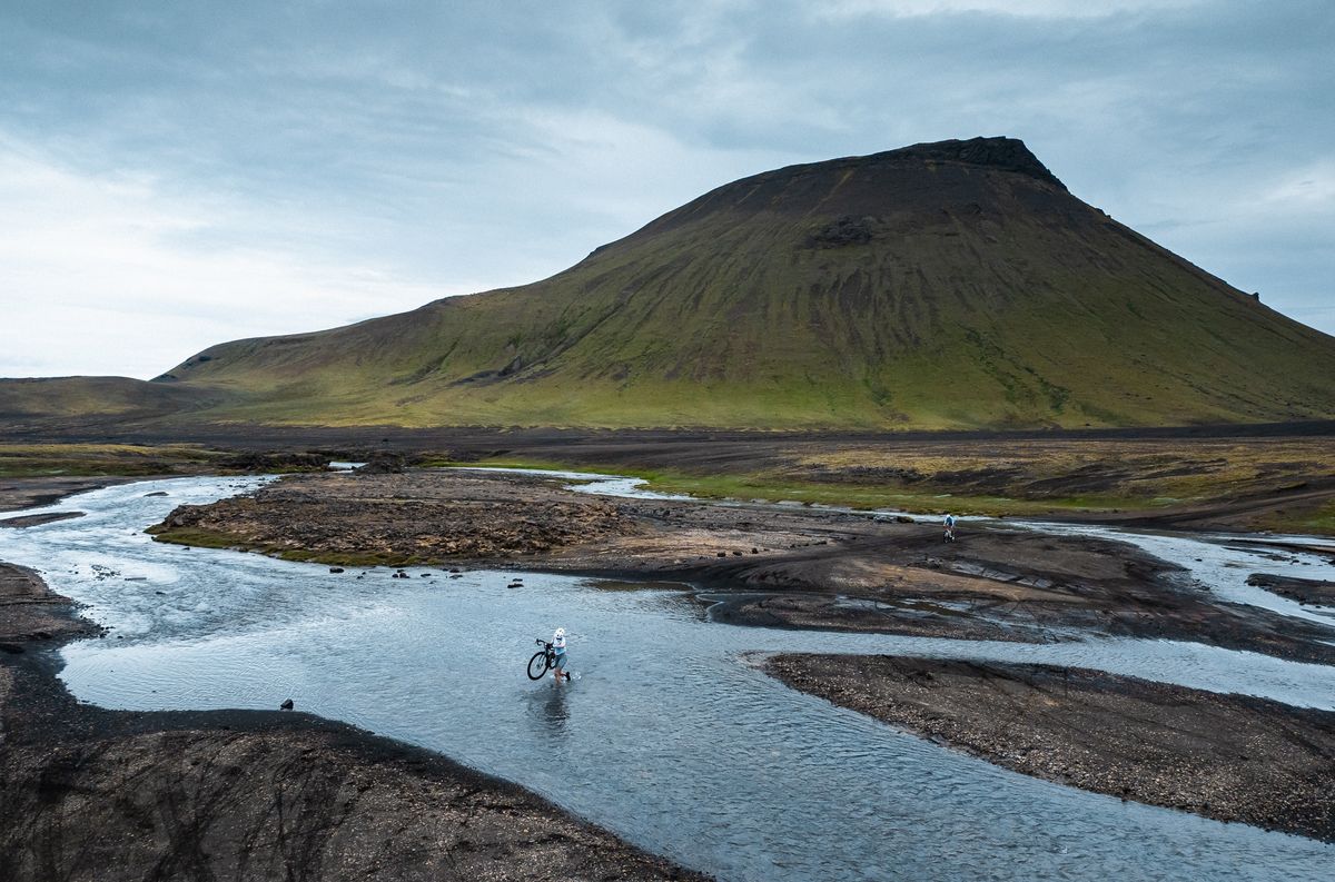 Riders negotiate many water crossings at The Rift across volcanic terrain